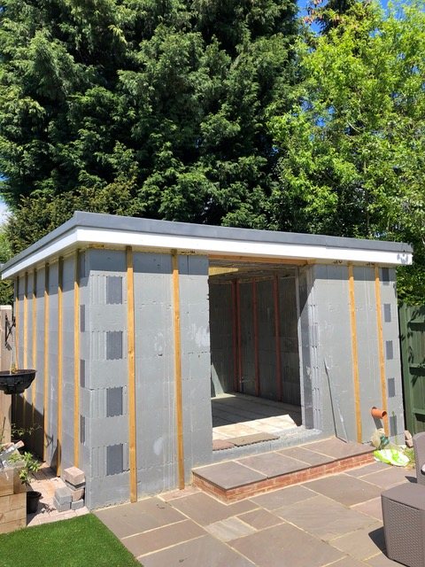The annex with roof complete and vertical timber battens fixed to the walls