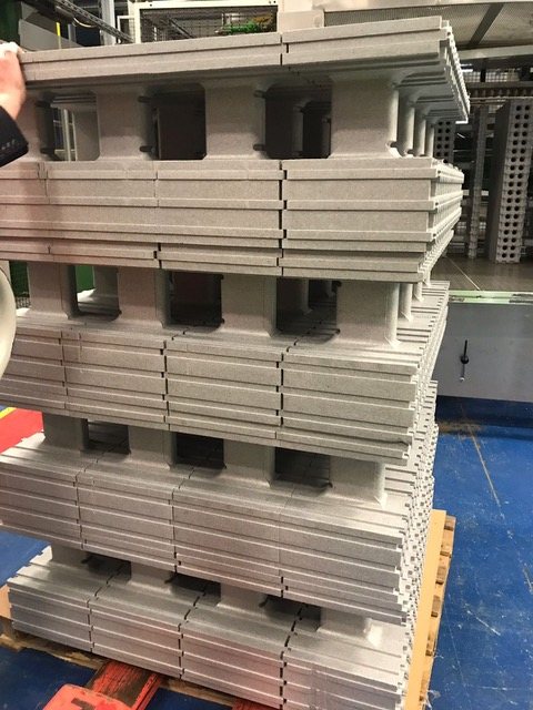 Formwork blocks stacked on a pallet inside the manufacturing plant