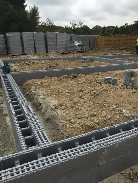 First course of formwork blocks running along a boundary fence