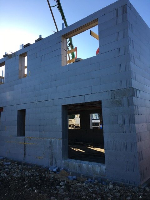 A completed poured wall shell with window and door openings formed